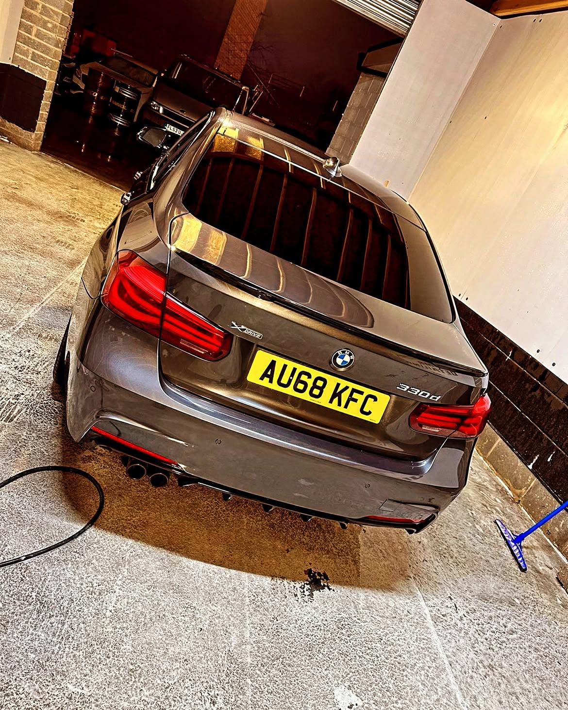 Grey BMW 330d xDrive gleaming under workshop lighting